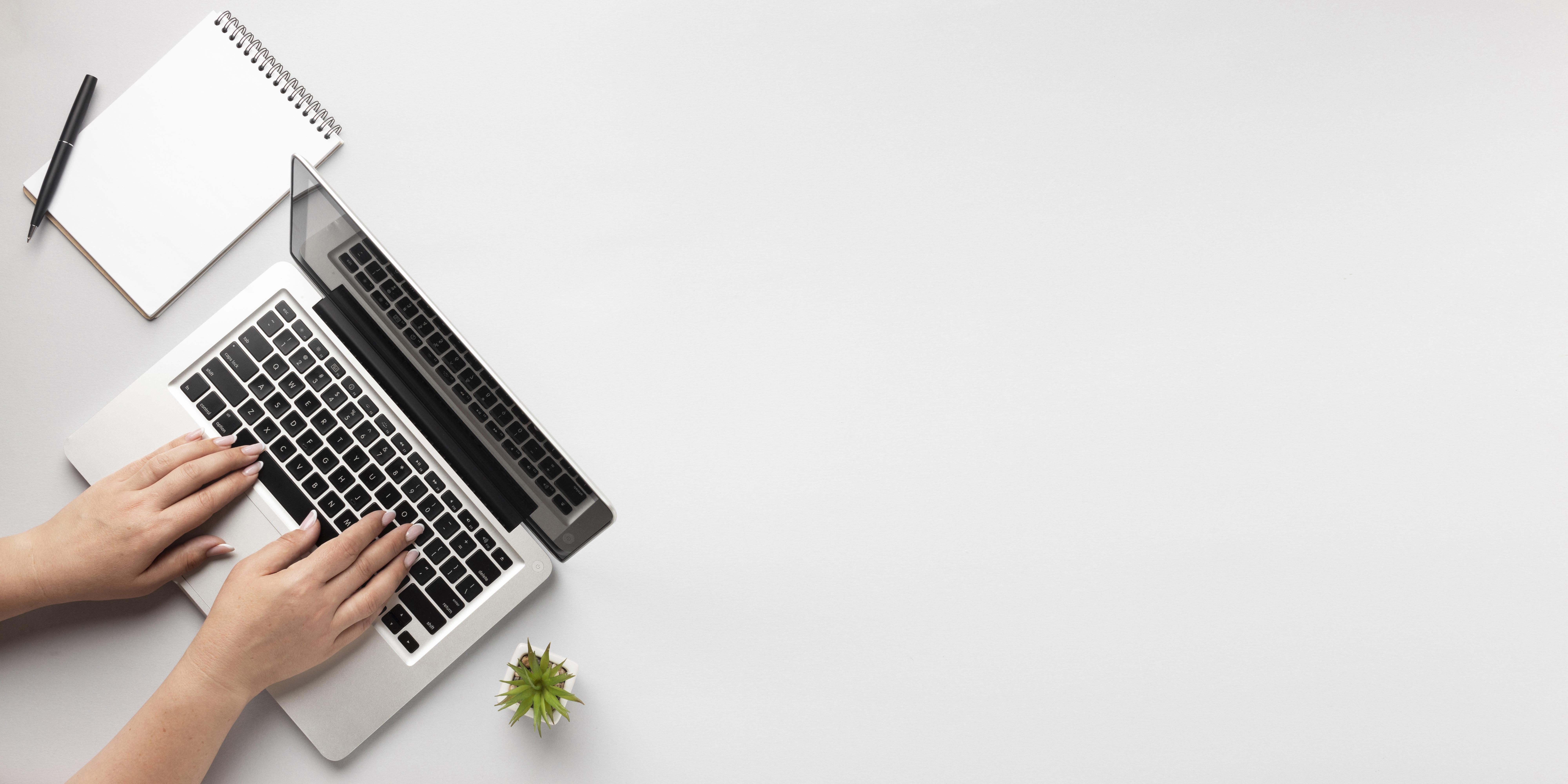 top-view-person-writing-laptop-with-copy-space